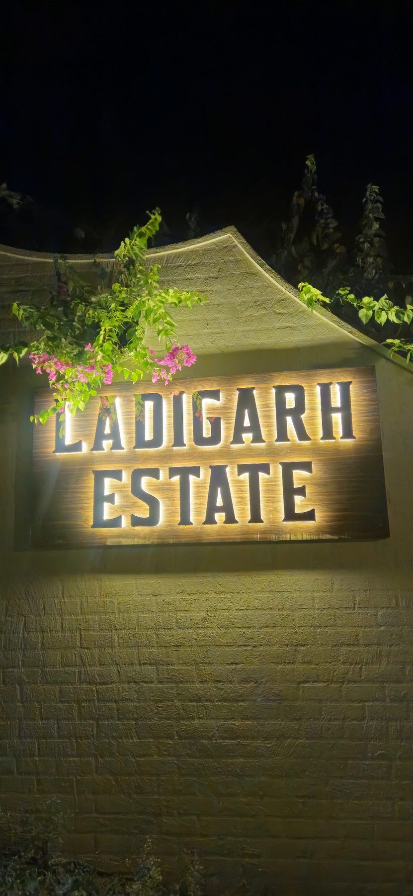 The lit Ladigarh Estate sign at night