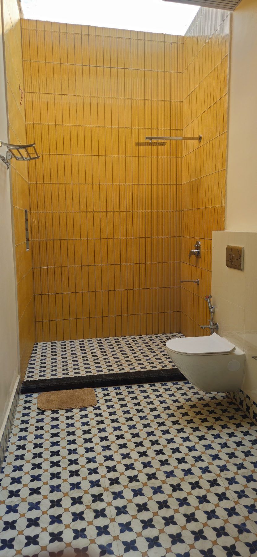 Cottage bathroom with yellow tiles and a patterned floor