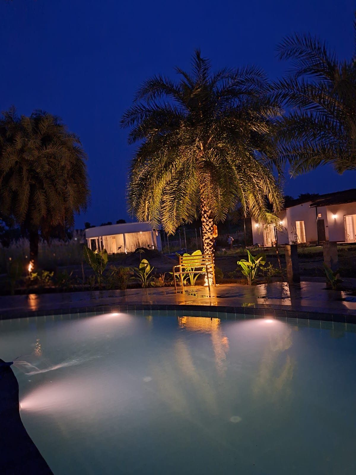The pool at night with the cottages beyond