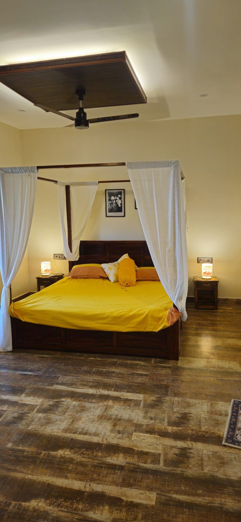 Four-poster bed with saffron linen